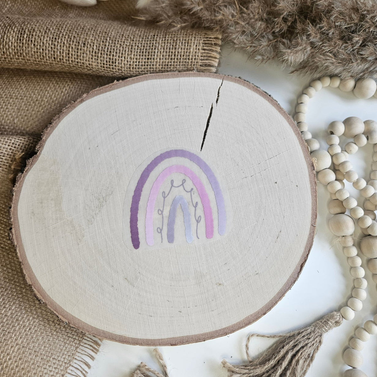 "Regenbogen rosa" Bügelbild zum Aufbügeln – niedlicher Boho-Regenbogen in Rosa-/Lilatönen mit Blütenzweigen im Aquarellstil auf Holzscheibe, handmade | Little Falili
